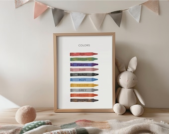 May include: A framed print with the word "COLORS" at the top, featuring a colorful crayon illustration. The crayons are labeled with their respective colors: red, green, purple, pink, black, blue, yellow, grey, orange, and brown. A stuffed bunny and a decorative banner are also in the image.