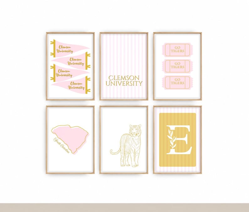 May include: A set of six framed wall art prints featuring Clemson University themes in pink, gold, and white. Designs include pennants, the text Clemson University, Go Tigers tickets, a South Carolina map, a tiger illustration, and the letter E.