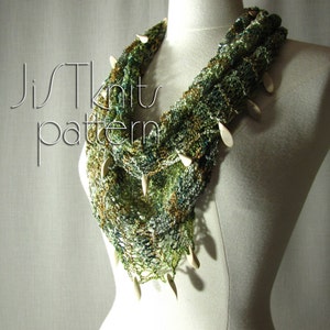 May include: A green, brown, and white crocheted scarf with white beads. The scarf is draped over a white mannequin.