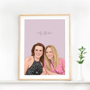 May include: A framed portrait featuring two women. One woman wears a black and white patterned top, the other a pink shirt. The text "My Bestie" is written in cursive at the top of the image.