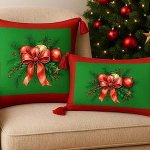 May include: Two Christmas cushions with red borders and tassels. The green centre features a red bow, baubles, and greenery. The cushions are on a beige chair, with a Christmas tree in the background.