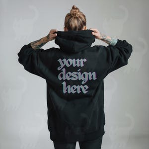 May include: Black hooded sweatshirt with the text "your design here" printed on the back in a glitchy, colourful font.