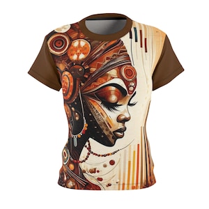May include: Brown t-shirt featuring a detailed illustration of a woman's face with intricate patterns and warm colors. The design incorporates shades of brown, orange, and beige, creating a striking visual effect. The shirt has brown sleeves and a brown collar.