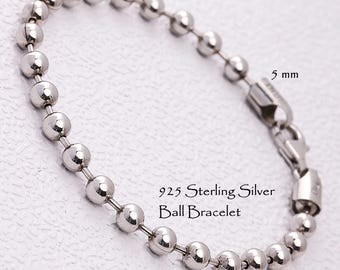 May include: A 925 sterling silver ball bracelet featuring polished spherical beads connected by a thin metal chain. The bracelet includes a lobster claw clasp and is labeled with the text 5 mm and 925 Sterling Silver Ball Bracelet.