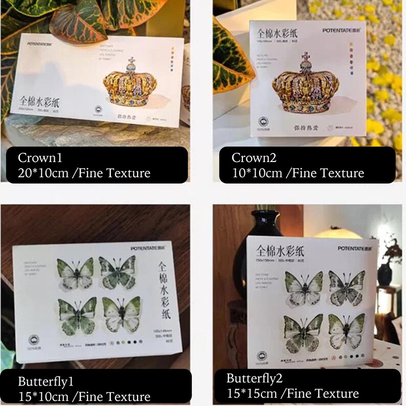 K&ouml;nnte beinhalten: Vier Sets Aquarellpapier mit Illustrationen. Zwei Sets zeigen goldene Kronen, eines 20 x 10 cm und das andere 10 x 10 cm. Die anderen beiden Sets zeigen Schmetterlingsdesigns, eines 15 x 10 cm und das andere 15 x 15 cm.