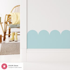 May include: A light blue wall with a scalloped border. The wall is painted in the color "Glacier" by Graphic Spaces.