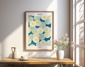 May include: Framed art print featuring a floral pattern of white and light blue flowers with yellow centers on a dark blue background. The print has Japanese text at the top and bottom. The artwork is displayed on a wooden table.