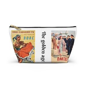 May include: A white zippered pouch with two vintage travel posters. The left poster features a woman in a red and orange dress dancing with the text "THE CARIBBEAN FLY THERE BY B-O-A-C". The right poster features a plane and people with the text "The golden age super service at your command QANTAS".