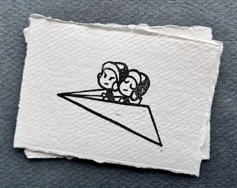 May include: Black and white illustration of two people in a paper airplane. The people are wearing hats and have simple facial features.