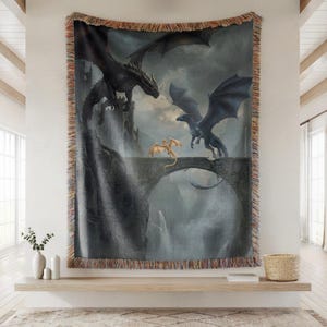 May include: A woven tapestry featuring a fantasy scene with dragons. The artwork depicts a castle, a stone bridge, and several dragons in flight. The tapestry has a fringed border and is displayed on a wall.