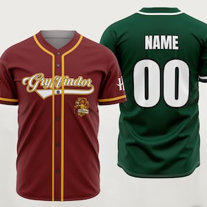 May include: A maroon baseball jersey with yellow trim, featuring the text Gryffindor and a crest on the front, alongside a dark green baseball jersey with the text NAME and the number 00 in white on the back, both with short sleeves and buttons.