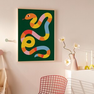 May include: An abstract illustration of a snake with a green background. The snake is made up of various geometric shapes in shades of orange, yellow, pink, and blue.