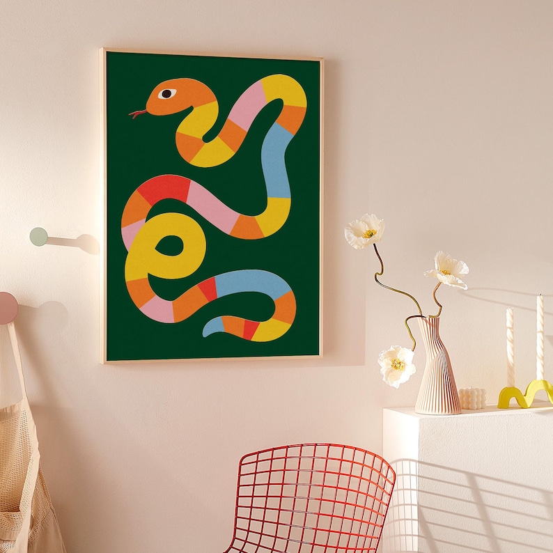 May include: An abstract illustration of a snake with a green background. The snake is made up of various geometric shapes in shades of orange, yellow, pink, and blue.