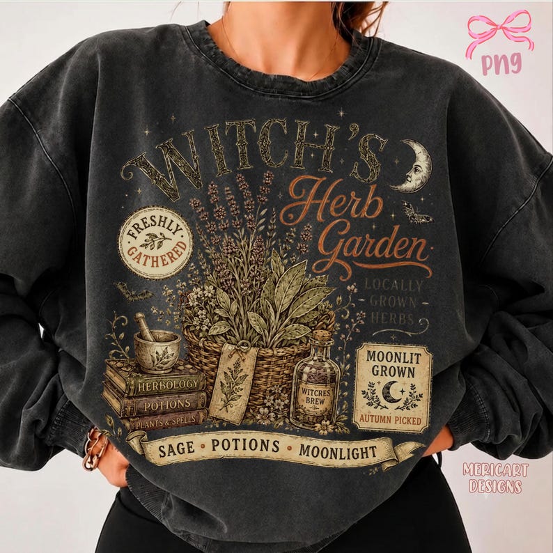 May include: A charcoal gray crewneck sweatshirt featuring a graphic print titled Witch's Herb Garden. The design includes a woven basket of herbs, a mortar and pestle, stacked books, a glass bottle, and text reading Freshly Gathered and Moonlit Grown.