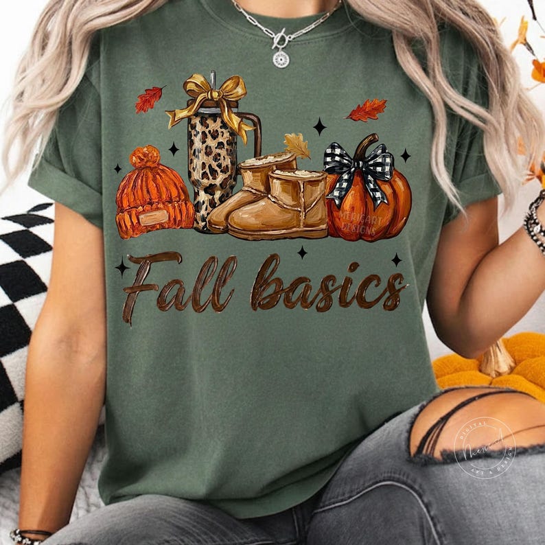 May include: A dark olive green t-shirt featuring a graphic print of a leopard print tumbler with a gold bow, a pair of tan boots, an orange knit beanie, and a pumpkin with a black and white plaid bow. The text Fall basics is printed below.