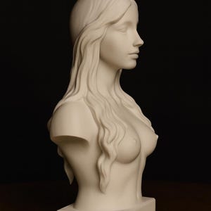 May include: A white bust sculpture of a woman with long flowing hair. The sculpture is a side profile, showing the face, shoulders, and upper chest. The bust is on a rectangular base, set against a dark background.