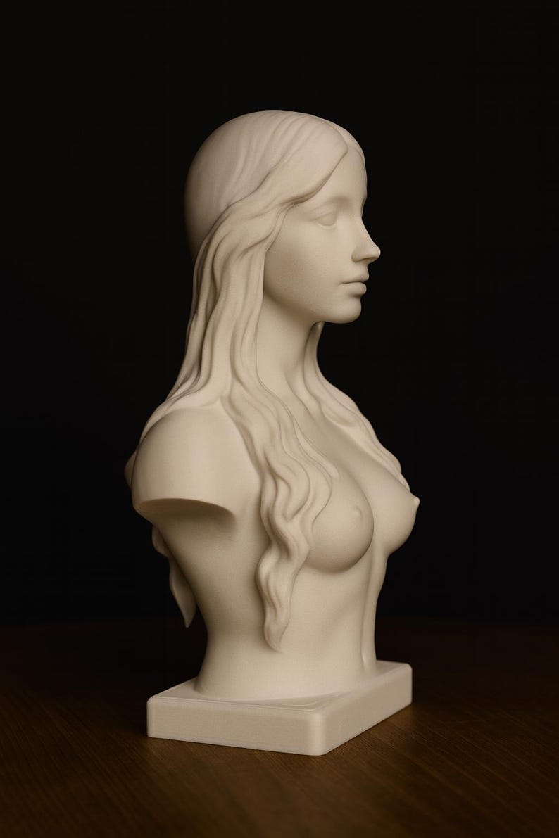 May include: A white bust sculpture of a woman with long flowing hair. The sculpture is a side profile, showing the face, shoulders, and upper chest. The bust is on a rectangular base, set against a dark background.