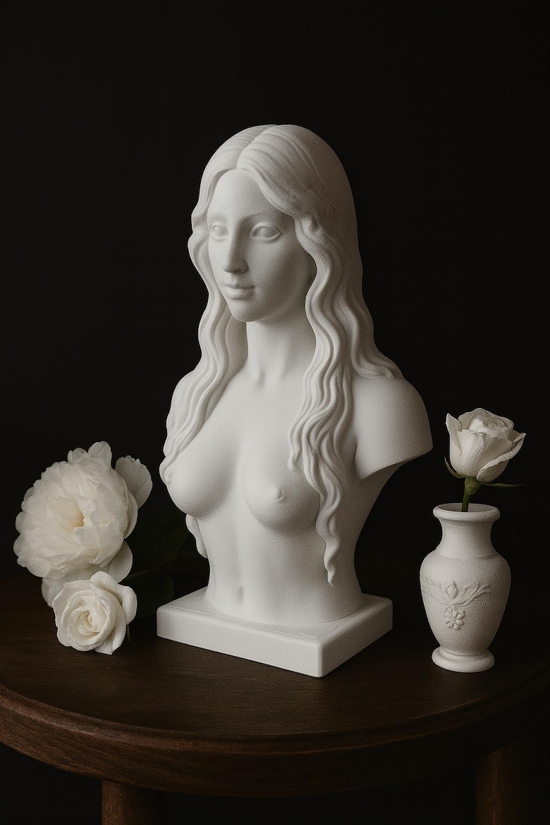 May include: A white plaster bust of a woman with long, wavy hair. The bust is on a square base and is accompanied by white roses and a small vase with a single white rose. The background is dark.