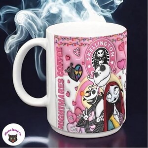 May include: A white ceramic coffee mug with a pink and white design featuring Jack Skellington and Sally from The Nightmare Before Christmas. The mug has the text "Nightmare Coffee" and "Skellington" on it.