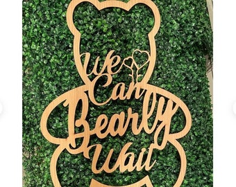 May include: Wooden cutout of a bear with the text "We Can Bearly Wait" and a heart design.