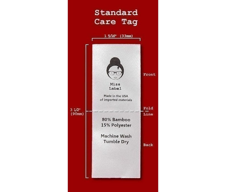 May include: A white rectangular fabric care tag measuring 1 5/16 inches wide by 3 1/2 inches long. The front features a logo with a person wearing glasses, the text Miss Label, and Made in the USA of imported materials. The back lists 80% Bamboo, 15% Polyester, Machine Wash, and Tumble Dry.