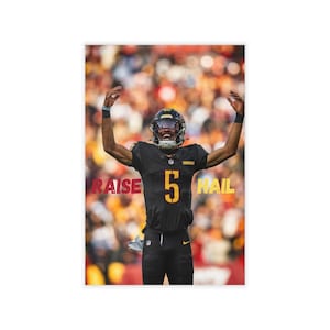 May include: A football player in a black and gold uniform with the number 5, raising his arms in celebration. The words "RAISE" and "HAIL" are visible in maroon. The player wears a black helmet with a gold visor.