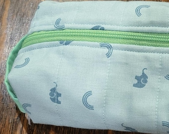 Toiletry bag with green fabric and a children print