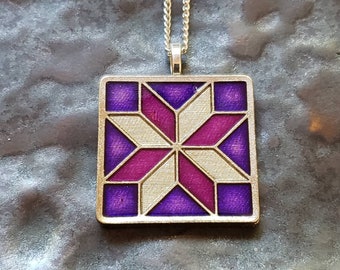 Quilt - Lemoyne Star Pendant.  Custom Coin, hand painted by Ann Nolen.  Size 1-1/4 x 1-1/4 inch. Purple & Pink