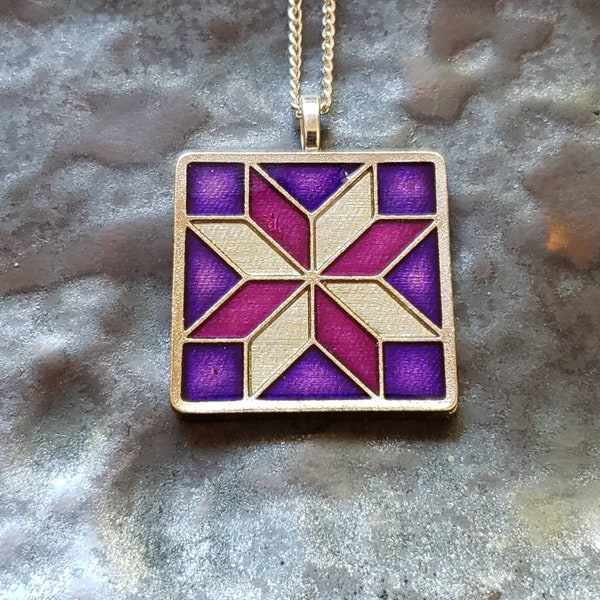 Quilt - Lemoyne Star Pendant.  Custom Coin, hand painted by Ann Nolen.  Size 1-1/4 x 1-1/4 inch. Purple & Pink