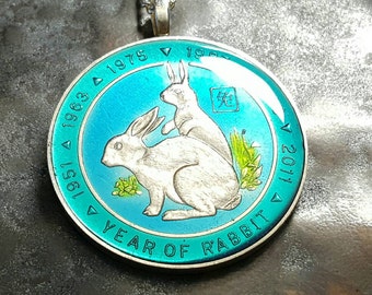 Somalia - Year of the Rabbit Coin Pendant. Hand Painted Coins by Ann Nolen. Coin size Large, about 1-1/2 inch. Coin date 1999.