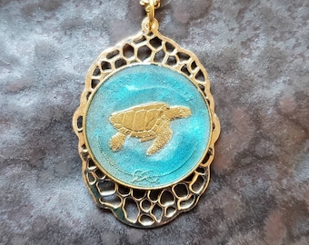 Maldives coin, Sea Turtle. Hand Painted by Ann Nolen. Filigree backing. Coin size Small, about 1 inch. Coin date 2008. Coin Jewelry.