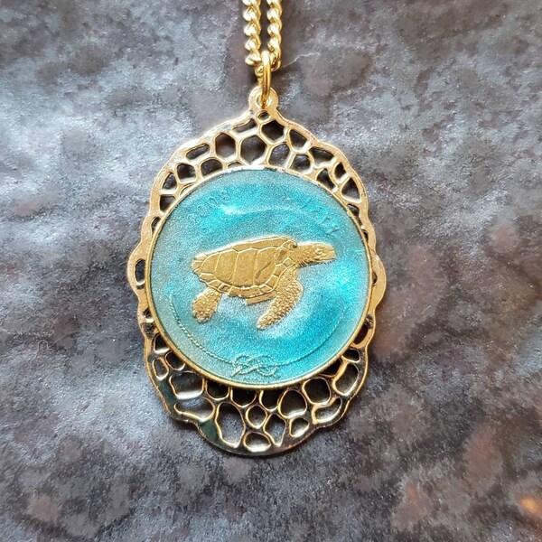 Maldives coin, Sea Turtle. Hand Painted by Ann Nolen. Filigree backing. Coin size Small, about 1 inch. Coin date 2008. Coin Jewelry.