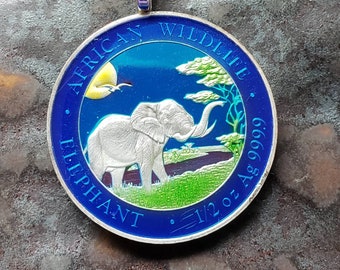 Coin from Somalia, hand painted by Ann Nolen. African Elephant pendant. Silver. Coin size Medium, about 1-1/4" dated 2019. Coin Jewelry.