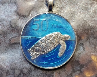 Coin from Cook Islands, Hand Painted by Ann Nolen. Hawkbill Sea Turtle pendant. Coin size Medium, about 1-1/4 inch. Coin date 1988.