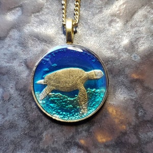 Turkey coin, hand painted by Ann Nolen. Loggerhead Sea Turtle Pendant. Coin size Small, about 1 inch. Coin date 2009.