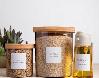 May include: Three clear glass jars with bamboo lids and white labels. The jars contain lentils, quinoa, and vegetable oil. The labels read "Lentils", "Quinoa, Grains & Rice", and "Vegetable Oil, Oil & Vinegar".