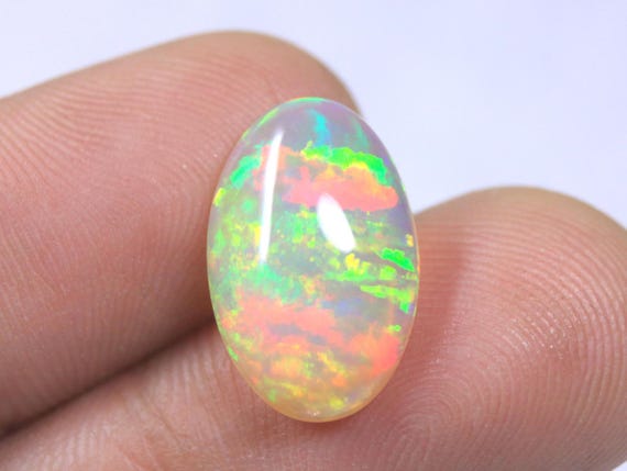 Oval Ethiopian Fire Opal Cabochon: 3.85 Carat Natural Play of Color Opal For Jewelry