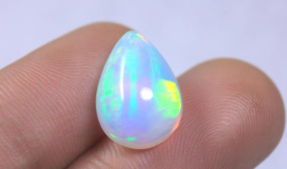 Pear Ethiopian Fire Opal Cabochon: 6.25 Carat Natural Play of Color Opal For Jewelry