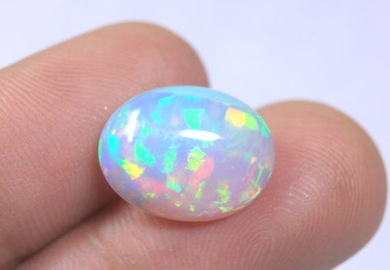 Oval Ethiopian Fire Opal Cabochon: 4.85 Carat Natural Play of Color Opal For Jewelry
