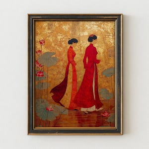 May include: Framed art print featuring two figures in long red and orange dresses, walking near lotus flowers. The background is a textured gold color. The artwork is in a black frame with a gold inner edge.