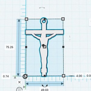 May include: A light-coloured crucifix pendant with a figure of Jesus. The pendant is 10.16 cm wide and 7.62 cm tall. The cross has a loop at the top for hanging. The figure's arms are outstretched on the cross.