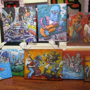 May include: A collection of framed paintings with various colorful abstract designs and cityscapes. Some paintings feature musicians playing instruments, while others depict abstract geometric shapes and patterns.