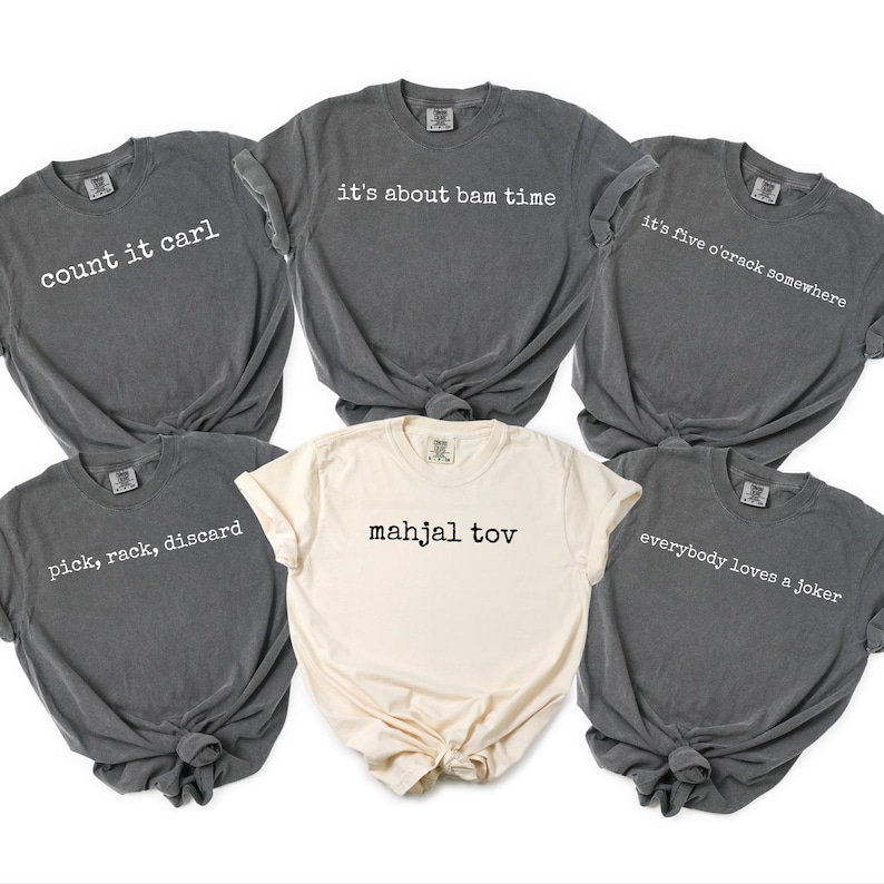 a collection of six gray t-shirts with various phrases printed on them, arranged in a circular pattern.