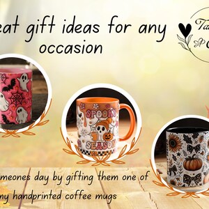 May include: Three hand-painted coffee mugs with Halloween designs. A pink mug has ghosts and spiderwebs. An orange mug says "Spooky Season" with a skull and pumpkin. A black mug has sunflowers and pumpkins. Text reads "Great gift ideas for any occasion."