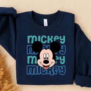 A navy blue sweatshirt with a large Mickey Mouse graphic printed on it.