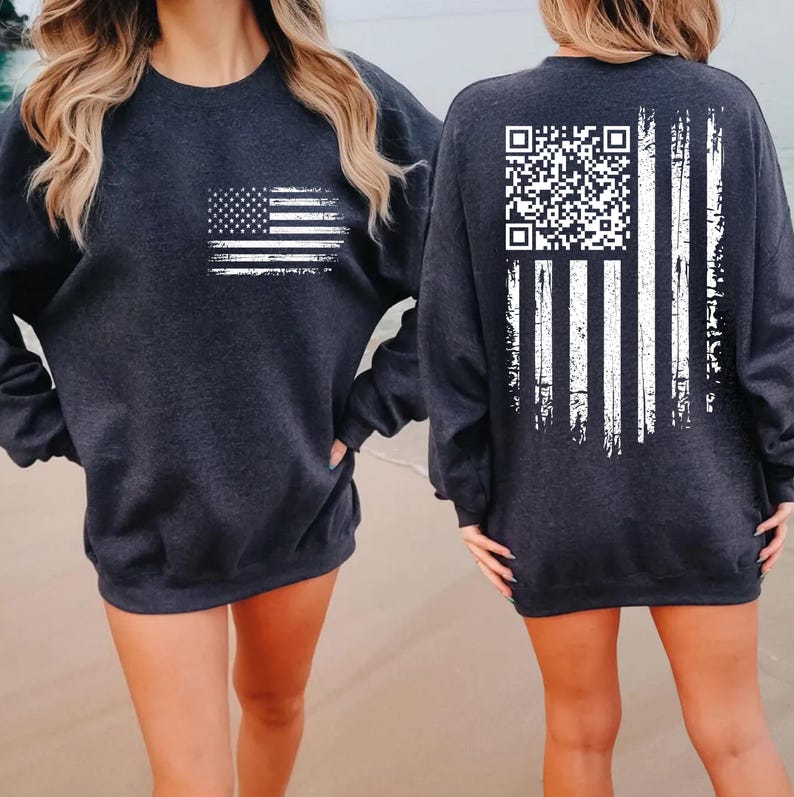 two women wearing black sweatshirts with a white American flag design on the front and a QR code on the back.