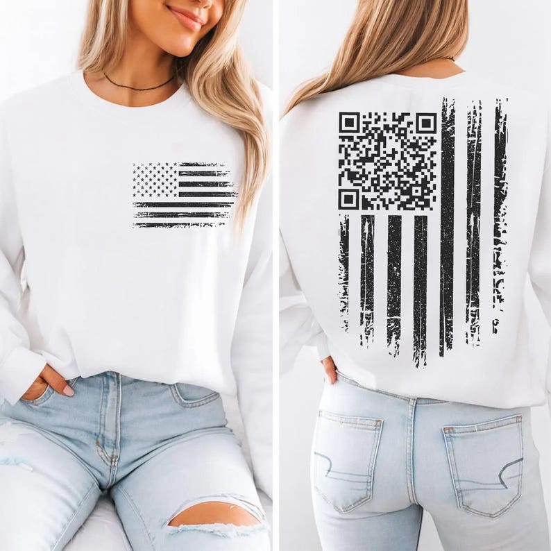 A woman wearing a white sweatshirt with an American flag design and a QR code printed on the back.