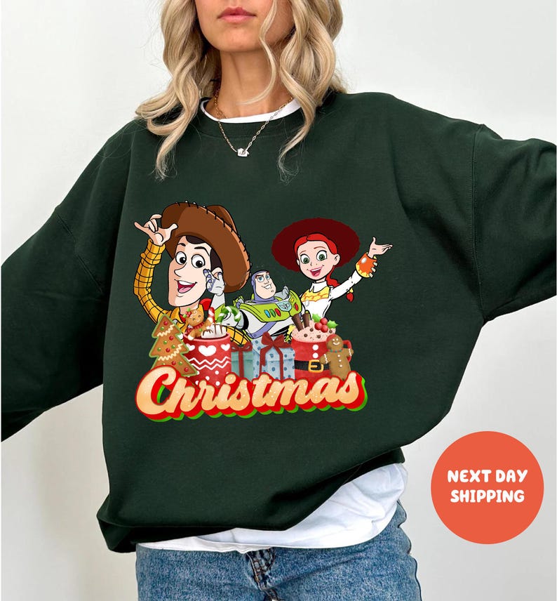 A woman wearing a green sweater with a Christmas-themed graphic of characters from the Toy Story movie.