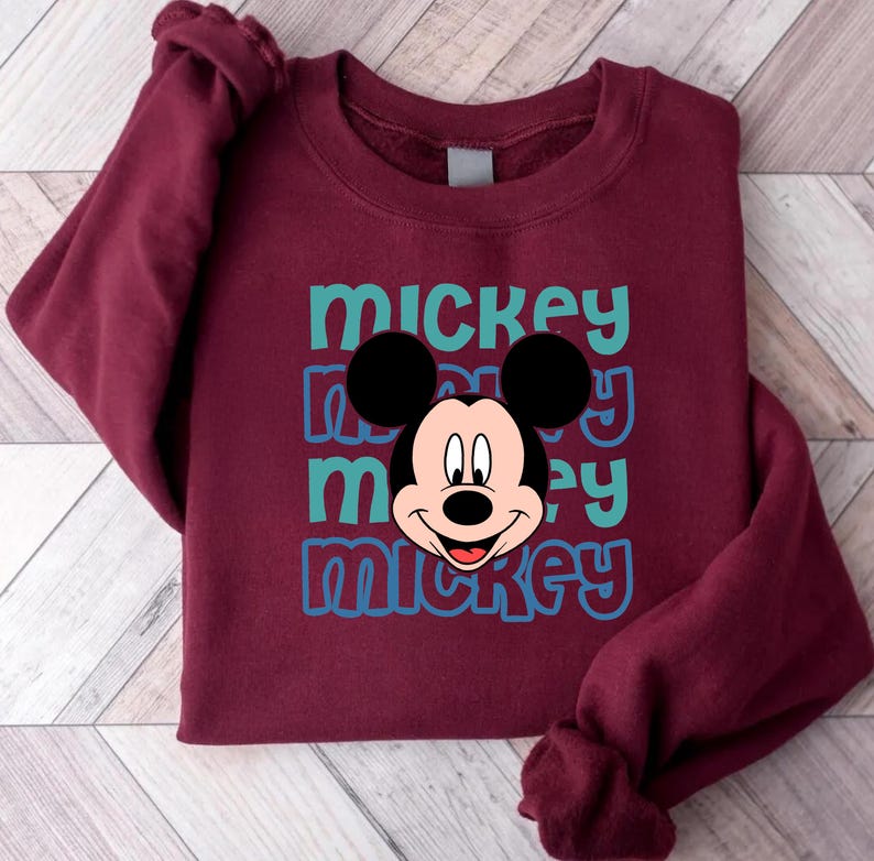 A burgundy sweatshirt with a Mickey Mouse graphic printed on it.