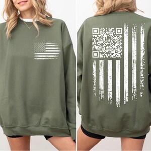 The image is a collage of two photos of a woman wearing a green sweatshirt with an American flag design and a QR code on the back.